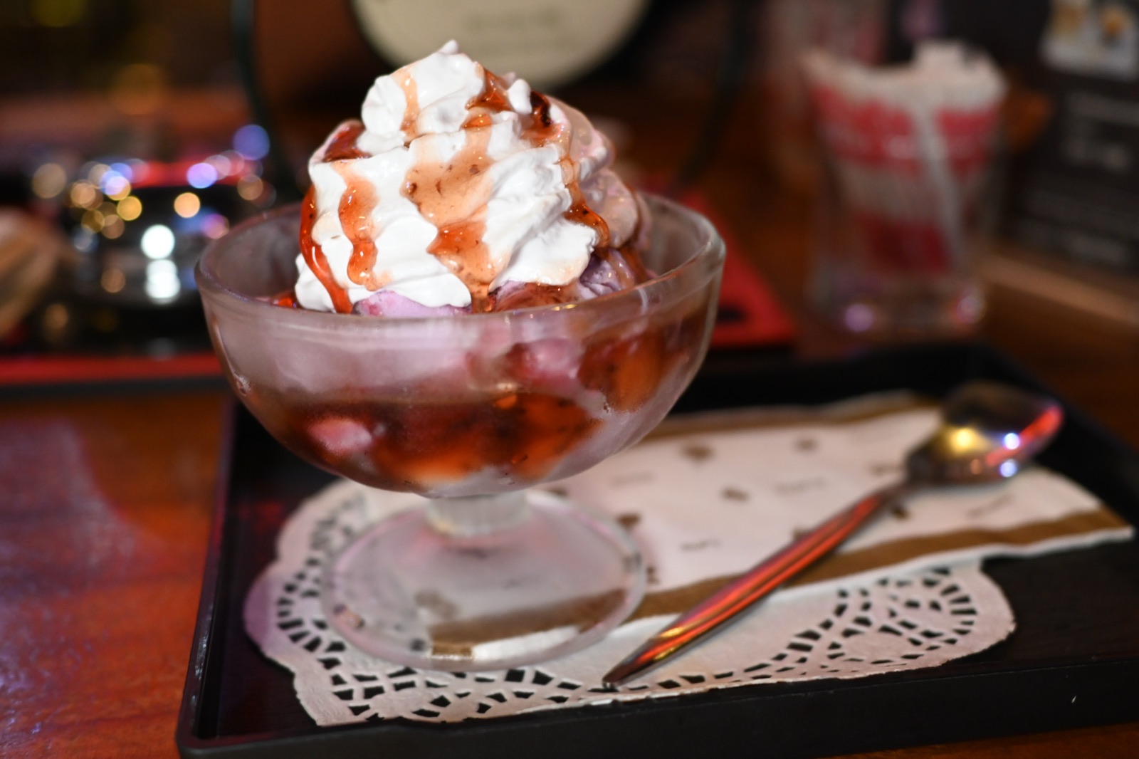 Strawberry sundae topped with whipped cream and syrup